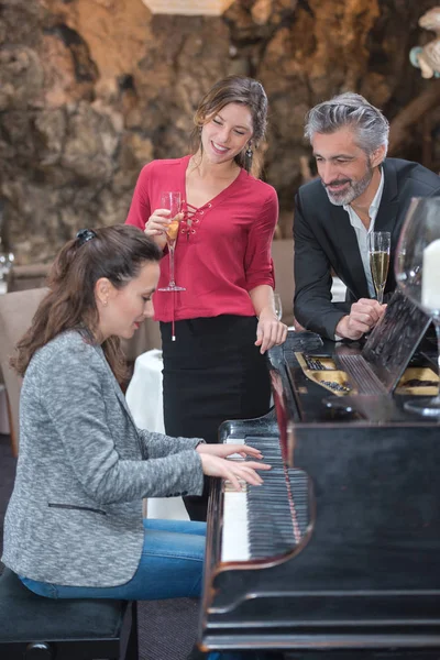 Пара средних лет слушает пианиста — стоковое фото