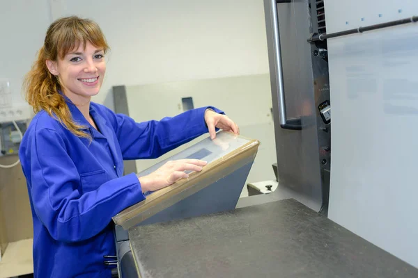 Woman programming electronic machine