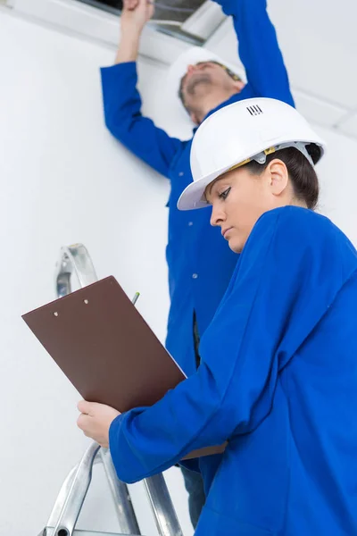 Electricians installing ceiling light — Stock Photo, Image