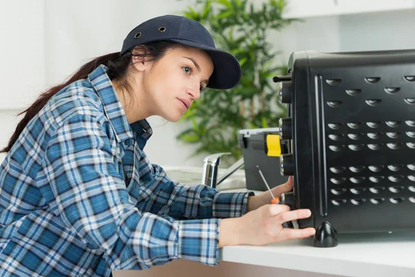 Electricista femenina trabajando en electrodomésticos — Foto de Stock