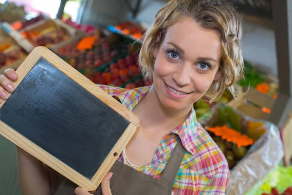 Smiling Female Staff Holding Board Supermarket — Stock Photo, Image