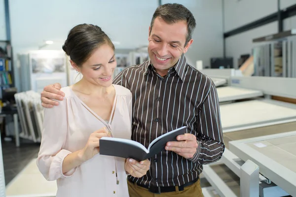 Pareja mirando el folleto — Foto de Stock