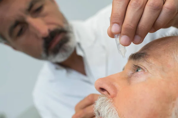 Arzt Verabreicht Älteren Menschen Augentropfen — Stockfoto