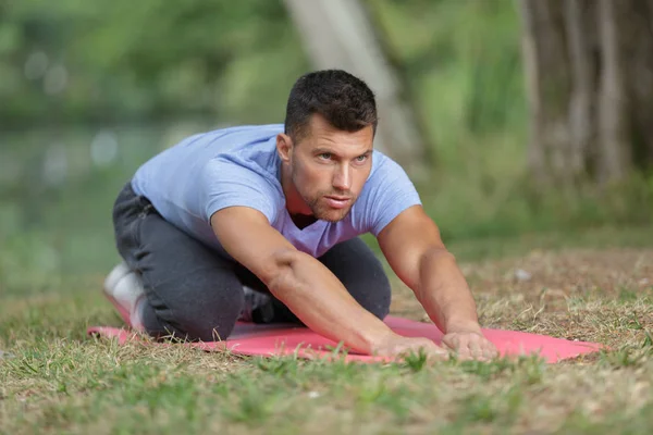 Man Stretching Out Muscles Park — Stock Photo, Image