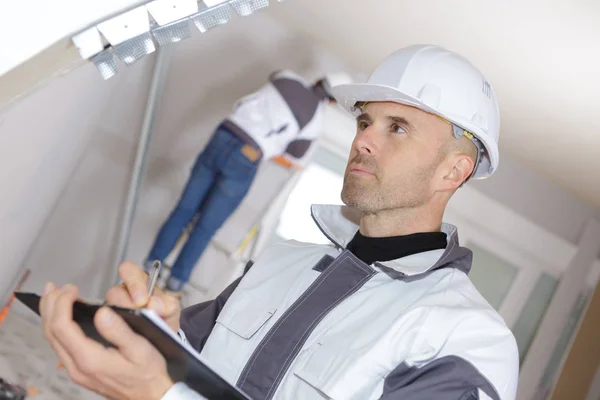 Worker Inspector Holding Clipboard Background Construction — Stock Photo, Image