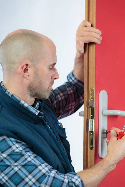 Young Male Carpenter Repairing Door Lock — Stock Photo, Image