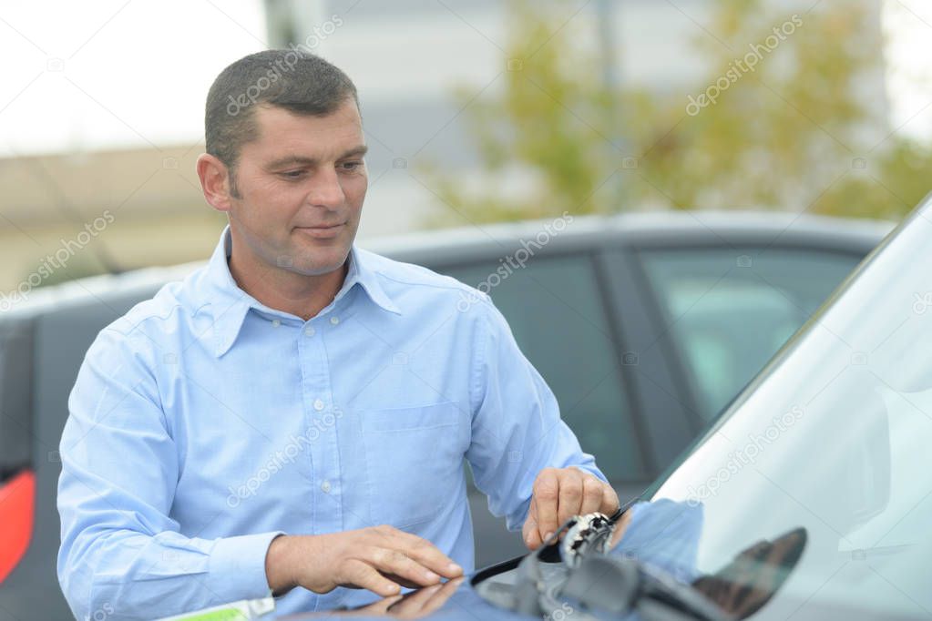 Man inspecting a car