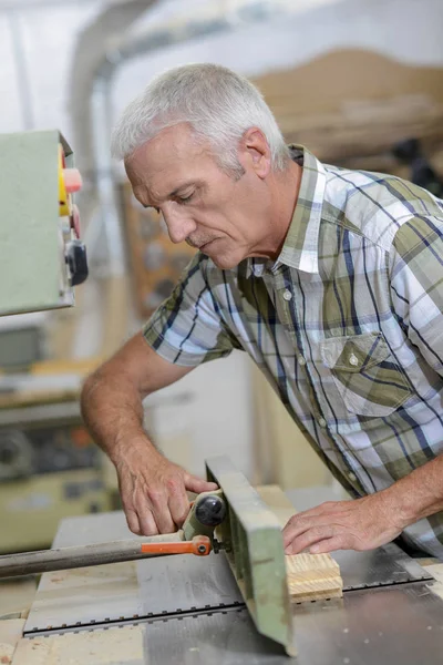 Carpenter stood by machinery — Stock Photo, Image