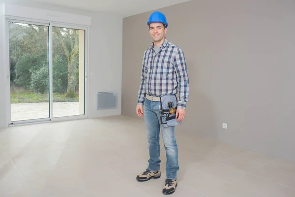 Young handsome architect standing in finished house — Stock Photo, Image