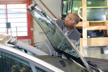 Mechanic fitting new windshield clipart