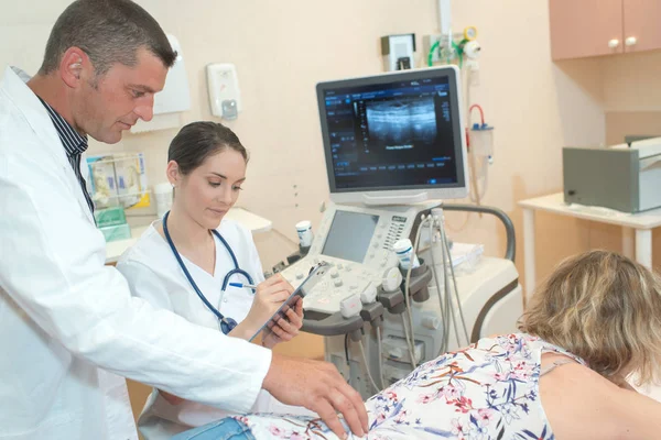 Kadın doktor tıbbi klinikte ultrason soruşturma yapma — Stok fotoğraf
