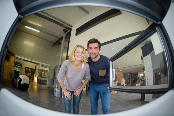 Fisheye view of couple from inside a woodburner — Stock Photo, Image