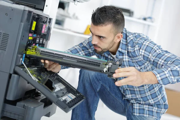 Tekniker åtgärda skrivaren genom skruvmejsel — Stockfoto