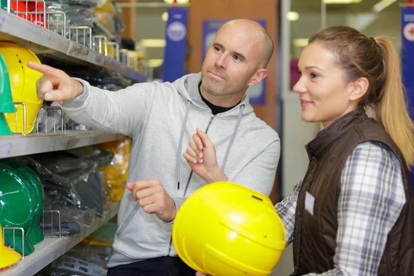 Man Chooses Protective Construction Helmet Store — Stock Photo, Image