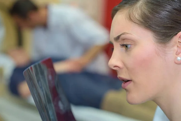 Young female doctor looking surprised at an x-ray — Stock Photo, Image