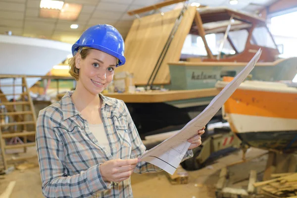 studying the boat's blueprint