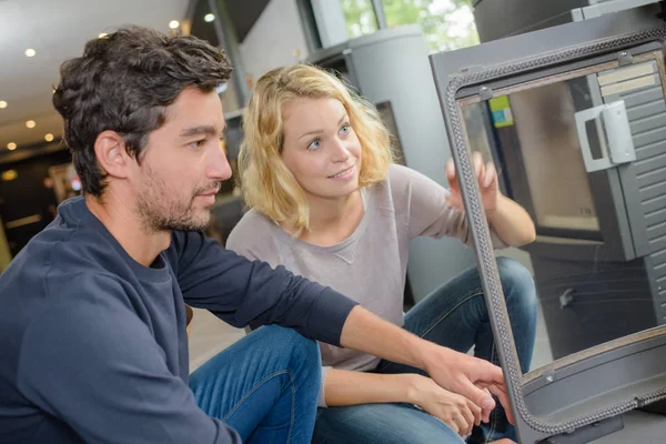 Inspecting a wood burner — Stock Photo, Image