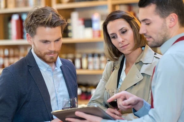 Sommelier met paar kiezen een fles wijn — Stockfoto