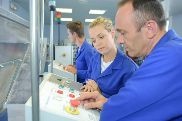 Young machine tender observing — Stock Photo, Image