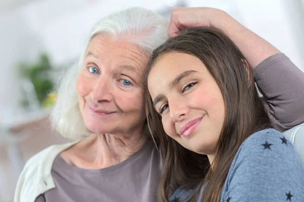 Senior lady with granddaughter happy together in domestic environment — Stock Photo, Image