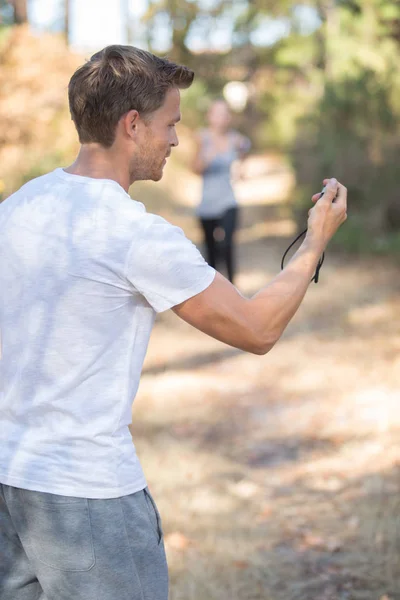 Man with stopwatch awaiting runner — Stock Photo, Image