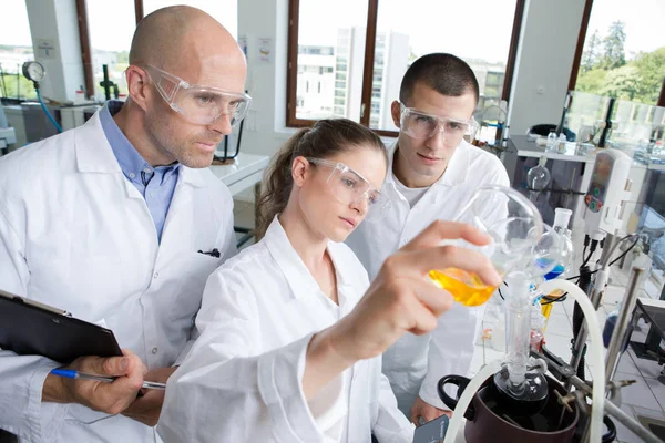 Jovens cientistas vestindo óculos de proteção em laboratório clínico — Fotografia de Stock