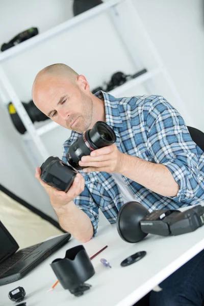 Fotógrafo profissional mostrando como usar a engrenagem da câmera — Fotografia de Stock