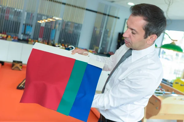 Man holding a fabric sample — Stock Photo, Image