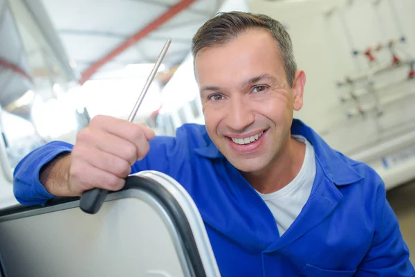 Mechanic holding screwdriver and mechanic — Stock Photo, Image
