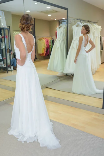 Female trying on wedding dress in a shop — Stock Photo, Image