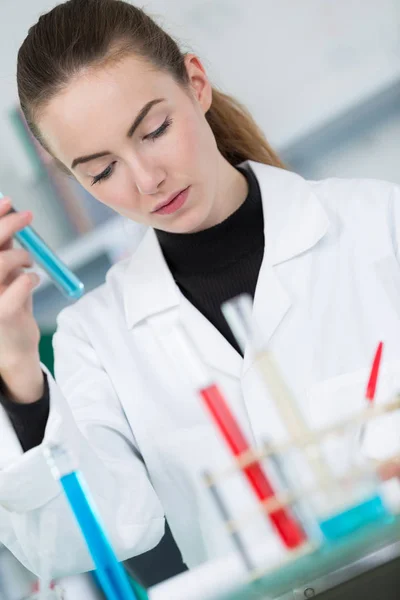 Woman with pipette and test-tubes — Stock Photo, Image