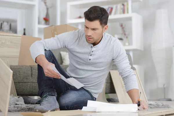 Hombre ensambla muebles y hombre — Foto de Stock