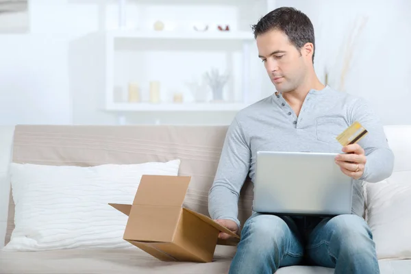 Man with credit card and computer laptop with box purchases — Stock Photo, Image