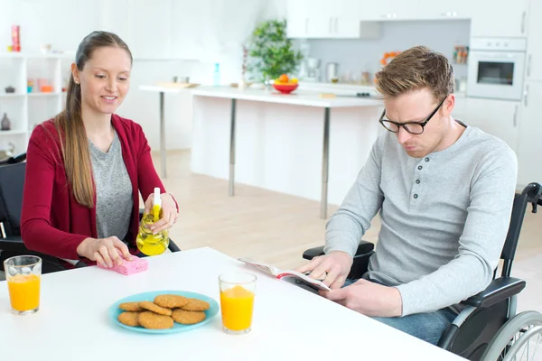 Happy young couple in wheelchair at home — Stock Photo, Image