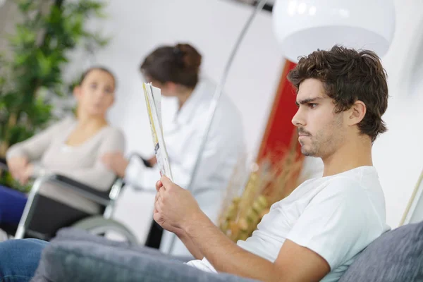 Verschillende mensen zitten in een wachtkamer van een ziekenhuis — Stockfoto