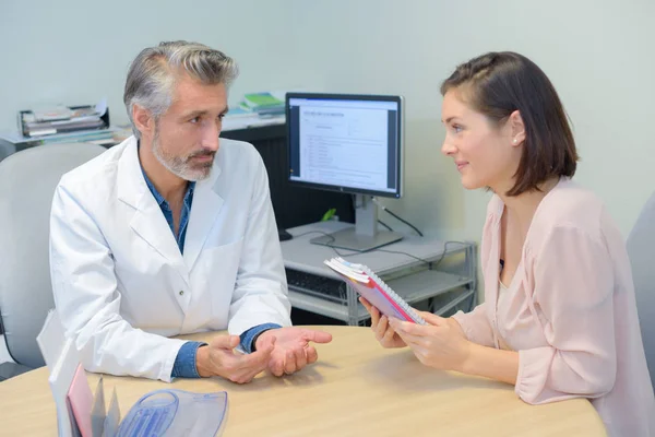 Patientin mit Arzt, Broschüre in der Hand — Stockfoto