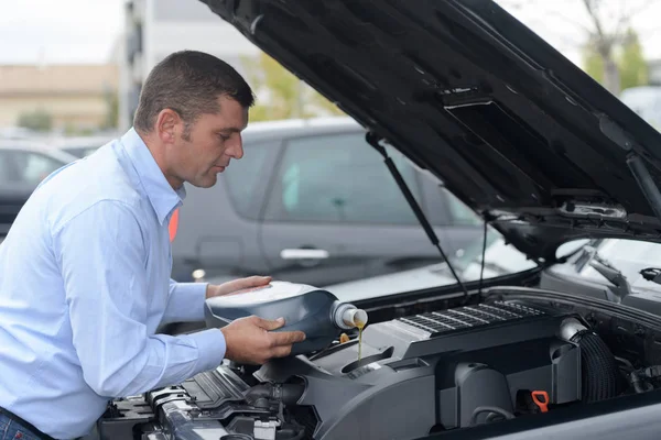 Mechaniker stellen Motoröl auf Motor um — Stockfoto