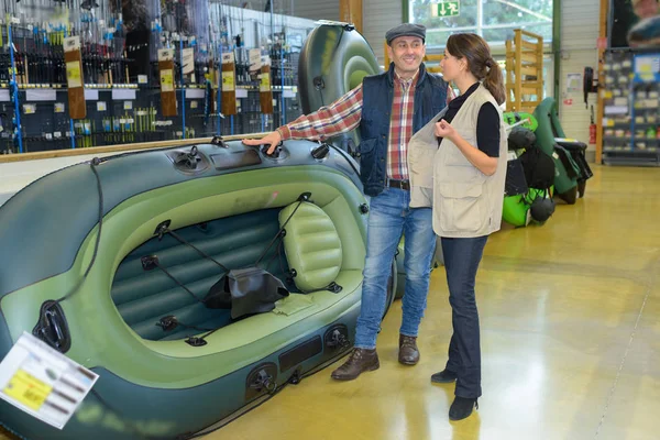 Man looking at inflatable boat in a shop