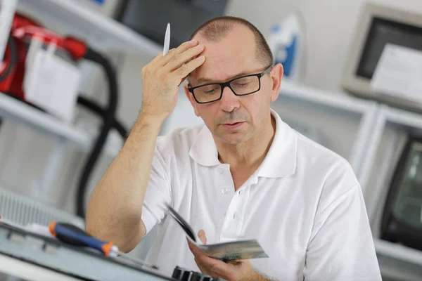 Repairman Reading Technical Manual — Stock Photo, Image