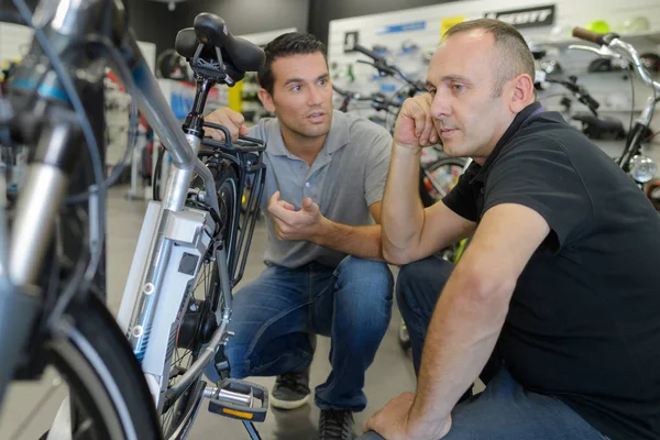 Mann Checkt Fahrrad Vor Kauf Sportgeschäft — Stockfoto