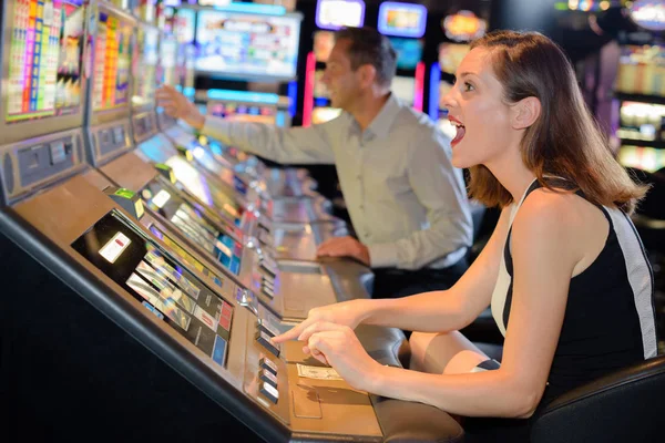 Woman cheering encouragement to arcade machine