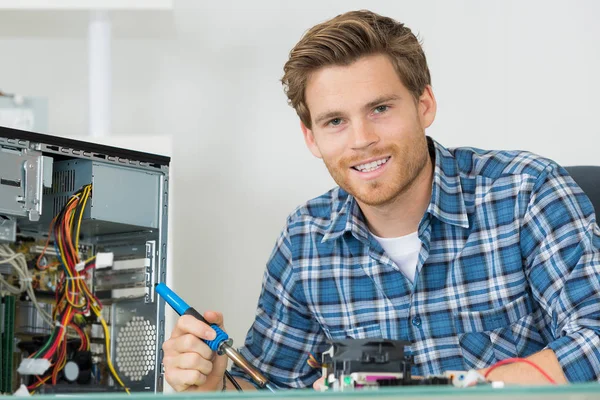 Portrait of computer technician holding soldering iron