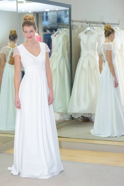 Κορίτσι Στέκεται Στο Φωτεινό Στούντιο Ένα Γαμήλιο Φόρεμα — Φωτογραφία Αρχείου