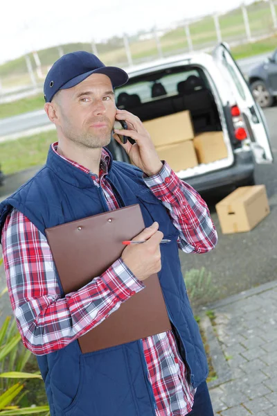 Delivery Man Holiding Clipboard Talking Telephone — Stock Photo, Image