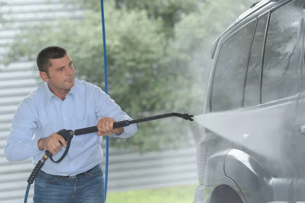 pressure water jet cleaning a car wheel