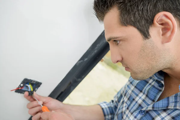 Man working on electric installation