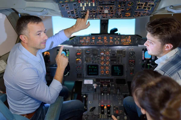 Man Showing Cockpit Controls Young People — Stock Photo, Image