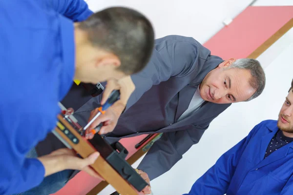 Male Apprentice Installing Door Lock Door — Stock Photo, Image