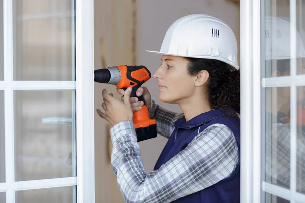 Young woman with a drill — Stock Photo, Image