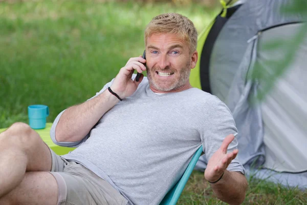 Denti da campeggio uomo grugnito mentre si parla al telefono — Foto Stock